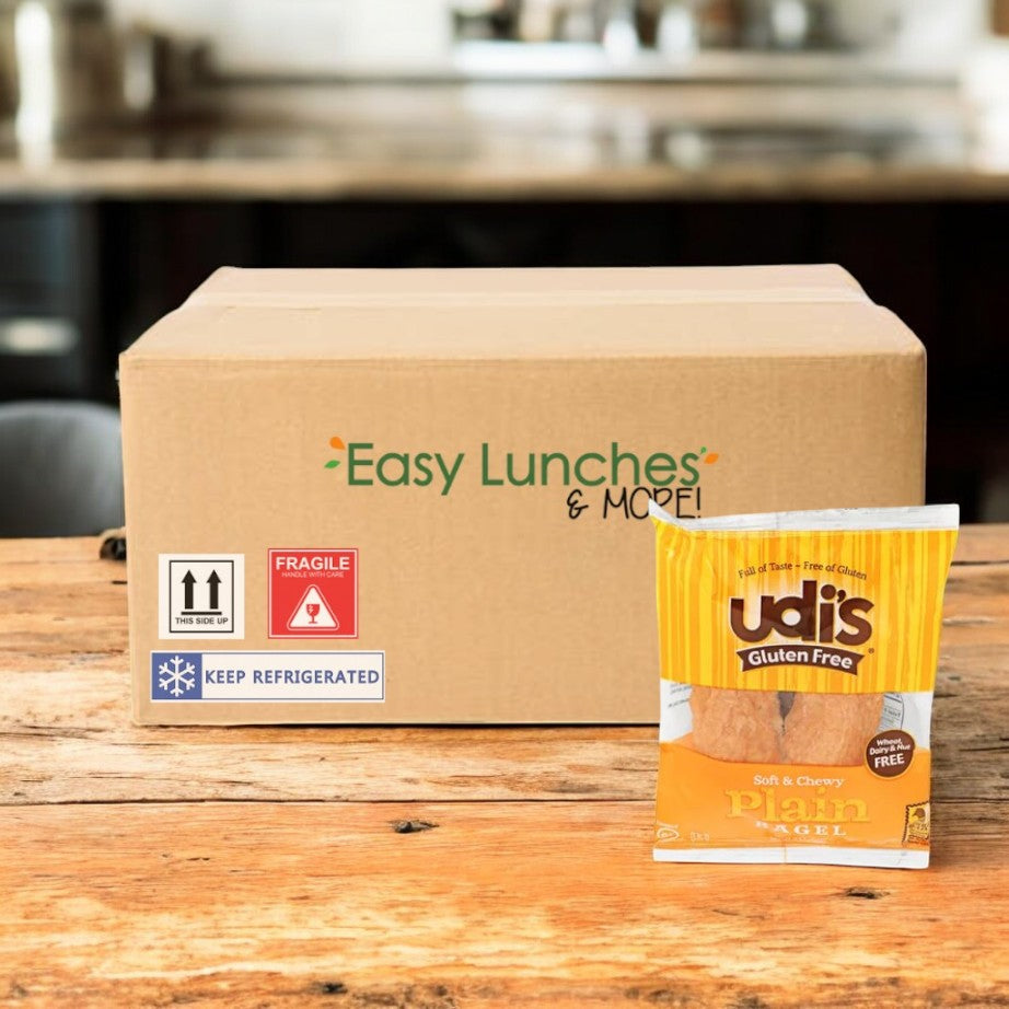 A cardboard box labeled "Easy Lunches & More" sits on a wooden table next to a package of Udi's Plain Bagel, 3.5 oz. - 1 Case, 24 Pack by Udi's, delivering classic flavor in every gluten-free bite.