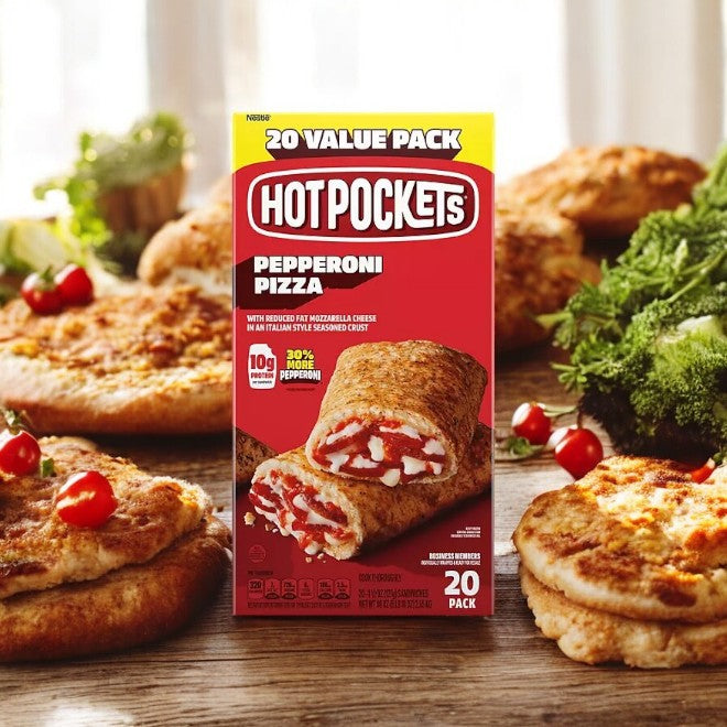 The Hot Pockets Pepperoni Pizza Sandwiches 20-pack, by Hot Pockets, sits on a wooden table surrounded by fresh pizzas and colorful vegetables—it's like having your own flavor variety pack at home.