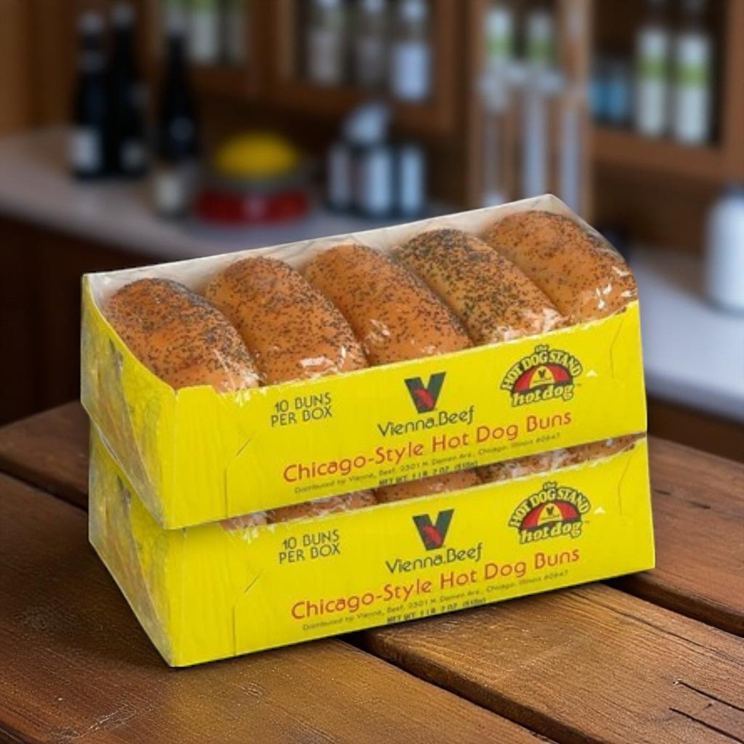The Vienna Beef & Maxwell St. Polish Sausage Combo Kit—featuring 16 hot dogs, 8 Polish sausages, and buns—is displayed stacked on a wooden surface in a kitchen, perfect for creating authentic Chicago-style meals.