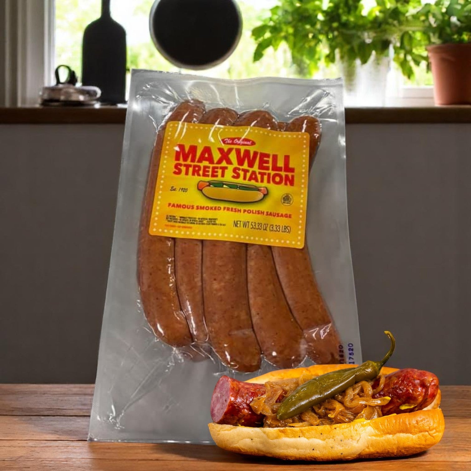 A 53.33 oz. pack of Vienna Beef Maxwell Street Station Famous Smoked Fresh Polish Sausage is on display, with a smoked sausage in a bun topped with onions and a pepper in front.