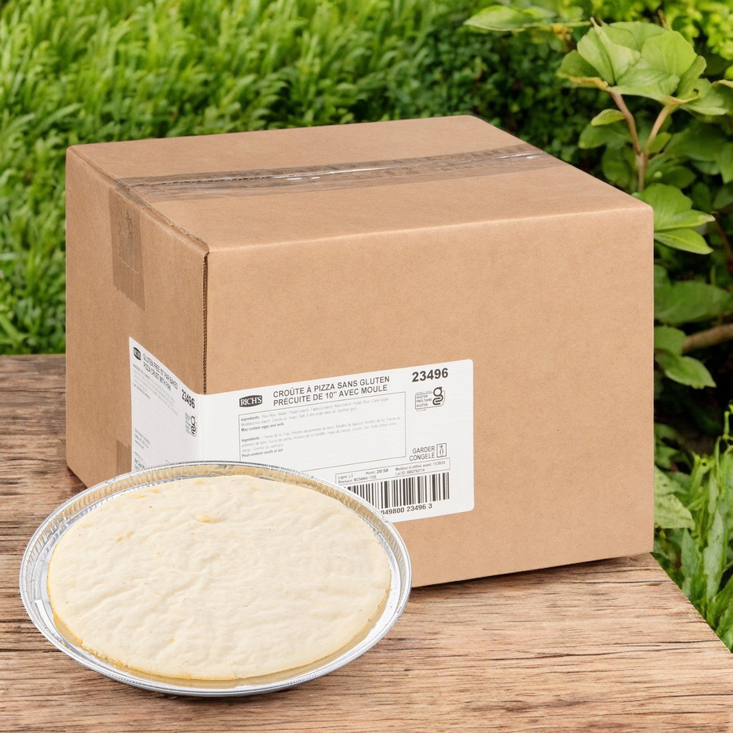 A Rich's 10-inch gluten-free par-baked pizza crust sits on a wooden surface, emerging from its labeled cardboard box, ready to delight.