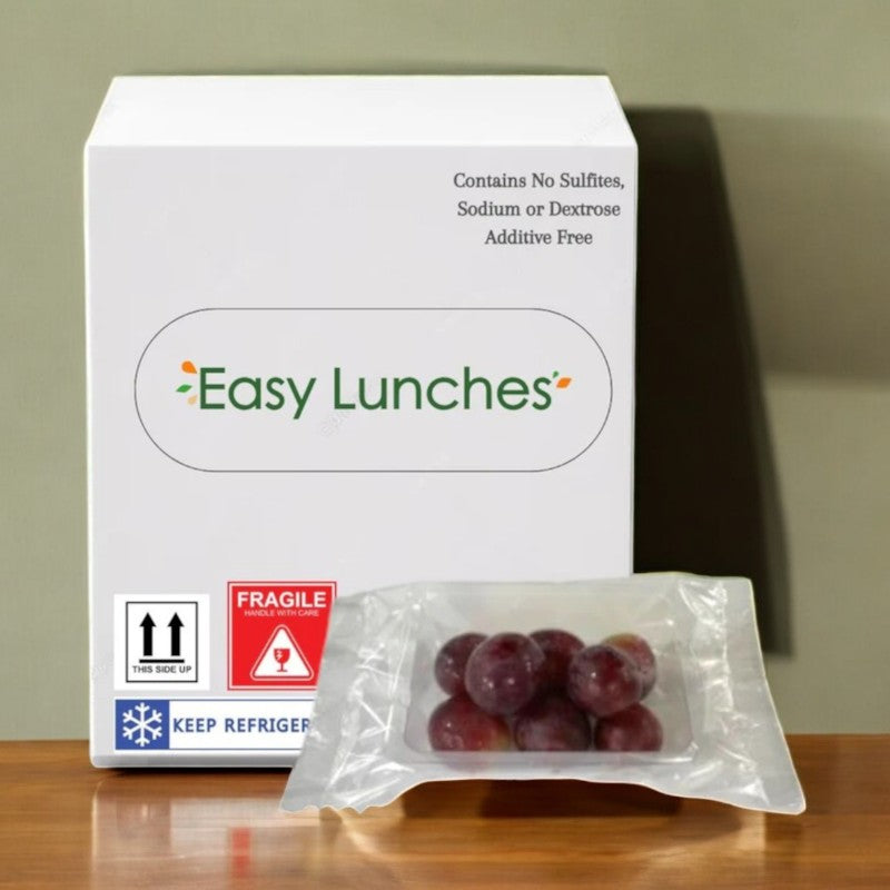 Box labeled "Easy Lunches" with a Red Seedless Grapes packet in front. Text: "Contains No Sulfites, Sodium, or Dextrose. Additive Free." Includes handling and refrigeration instructions. Perfect healthy snack on the go! Made to order, 7-day shelf life once received.