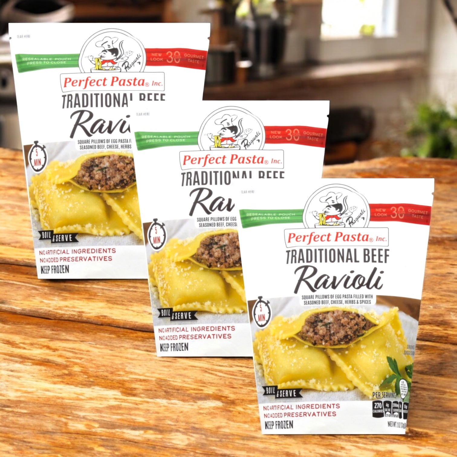 Three packs of Perfect Pasta Traditional Beef Ravioli by Perfect Pasta are displayed on a wooden surface with a blurred kitchen background.