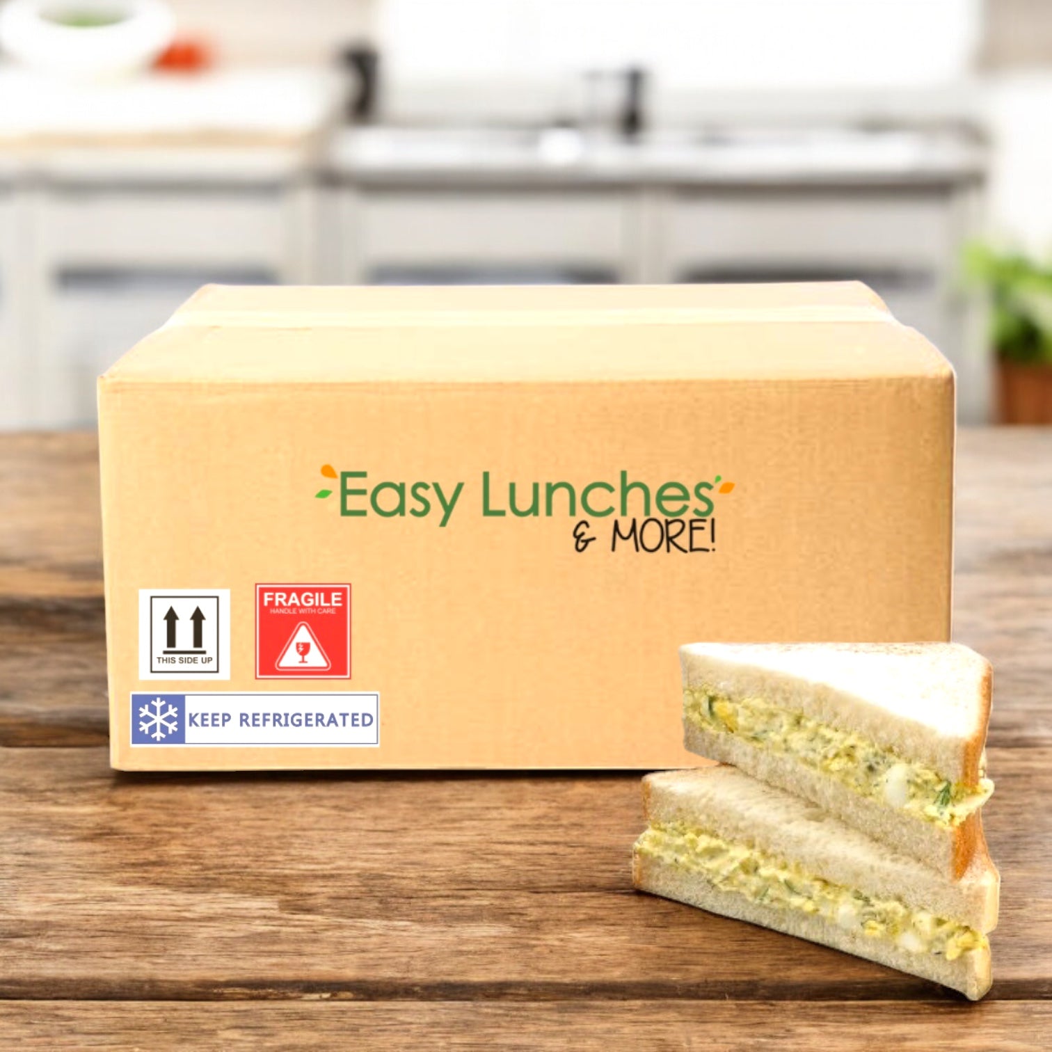A cardboard box labeled “Easy Lunches & More!” from E.A. Sween sits on a wooden table next to a Dill Egg Salad on Homestyle White Bread Sandwich Wedge (1 case, 8 count), with refrigeration and fragility labels visible. Ships frozen; 30 days shelf life in cooler!.