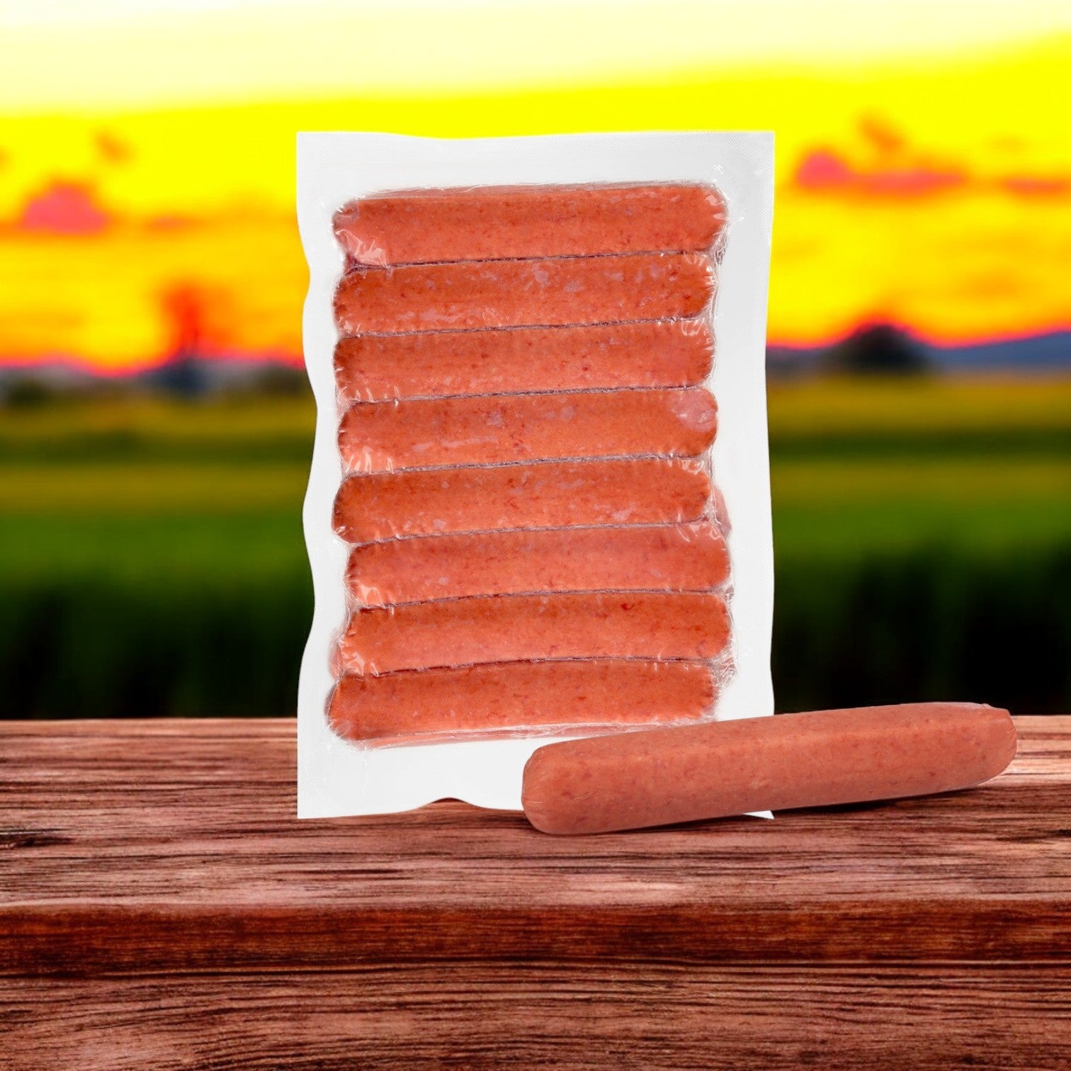 A case of Nathan's Famous Sausage Polish, containing 50 franks per 10 lb package, sits on a wooden surface against a sunset field backdrop, highlighting its premium quality.