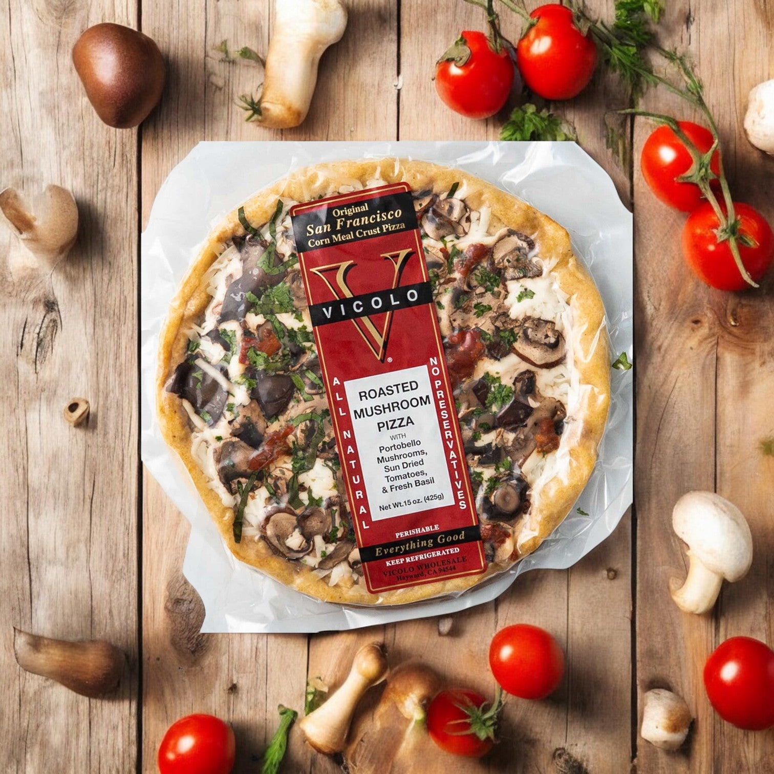 A packaged Vicolo Roasted Mushroom Pizza-1 Count from Vicolo rests on a wooden surface with fresh tomatoes and mushrooms, offering savory mozzarella flavor in every slice.