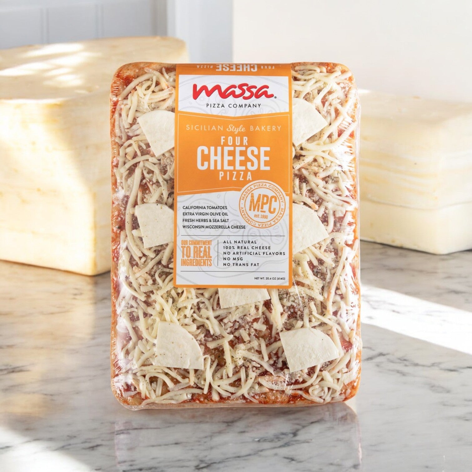 Packaging of Massa Pizza's 3 Pack Combo featuring Sicilian Bakery Four Cheese Pizzas with an artisan bakery crust on a marble countertop.