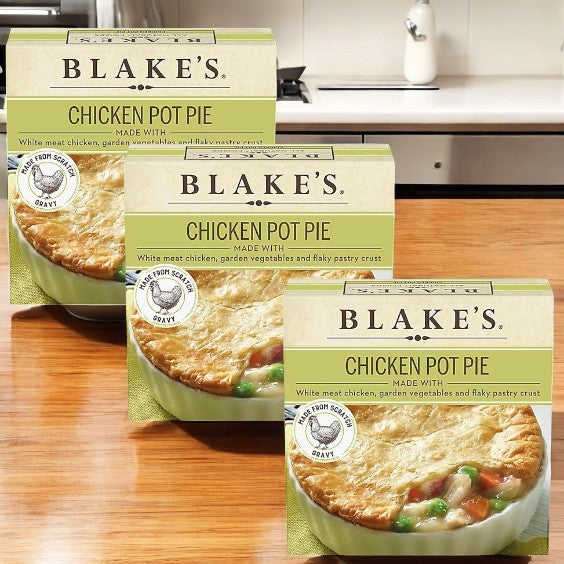Three boxes of Blake's All Natural Foods Chicken Pot Pie (3 Count) sit on a kitchen counter, each package showcasing the classic comfort meal made with savory vegetables and a flaky crust.