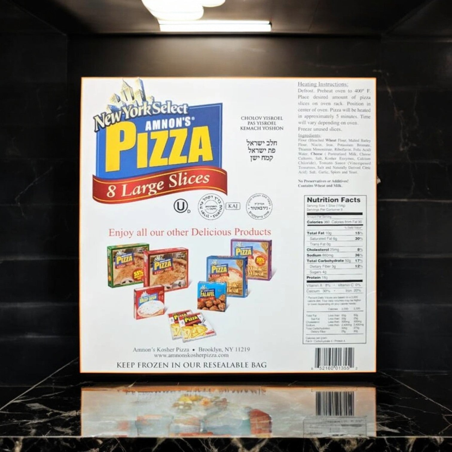 Amnon's Kosher Pizza Whole Wheat Low Fat Frozen, 36 oz. - 3 Count box contains kosher-certified pizzas with heating instructions and nutrition facts, presented on a marble-like surface and showcasing various other pizza products.