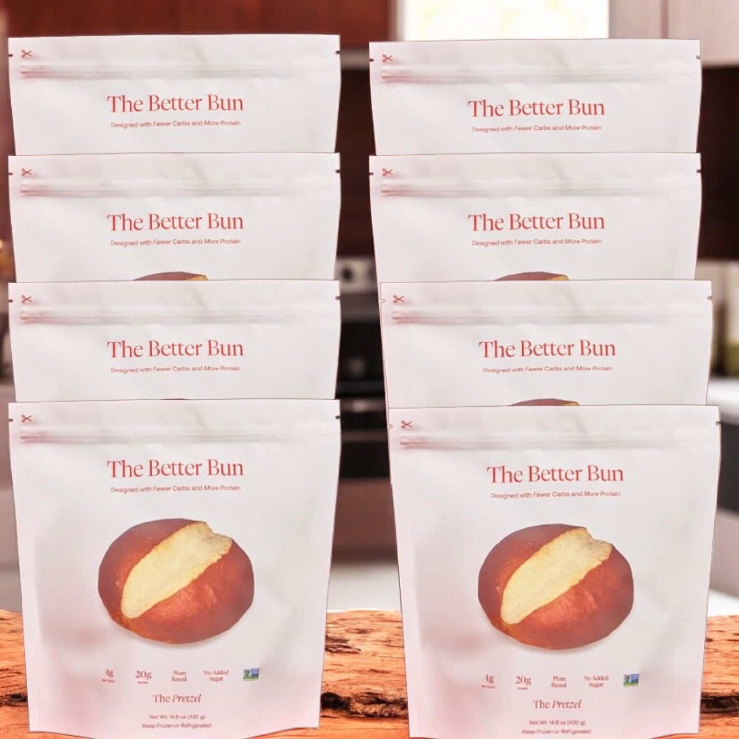 Eight packages of BetterBrand The Better Bun – Pretzel Style (8 Bag, 32 Bagels) are displayed in two rows on a wooden surface, each showing a pretzel bun image and highlighting Low Net Carbs and High Protein. In stock—ready to ship!.