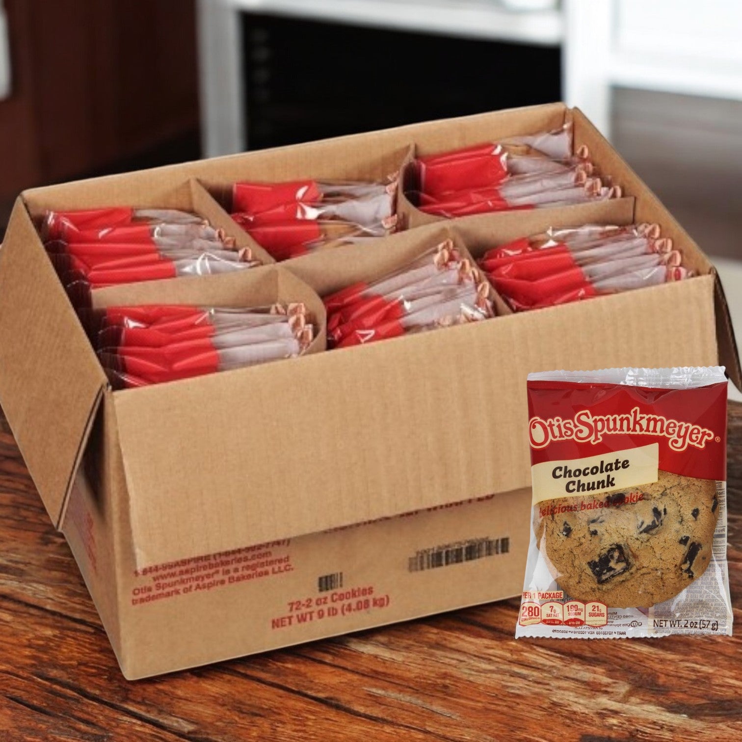 A 72-count case of Otis Spunkmeyer Individually Wrapped Chocolate Chunk Cookies, each 2 oz., sits on a wooden surface. These soft and chewy indulgences are perfect for satisfying sweet cravings anytime.