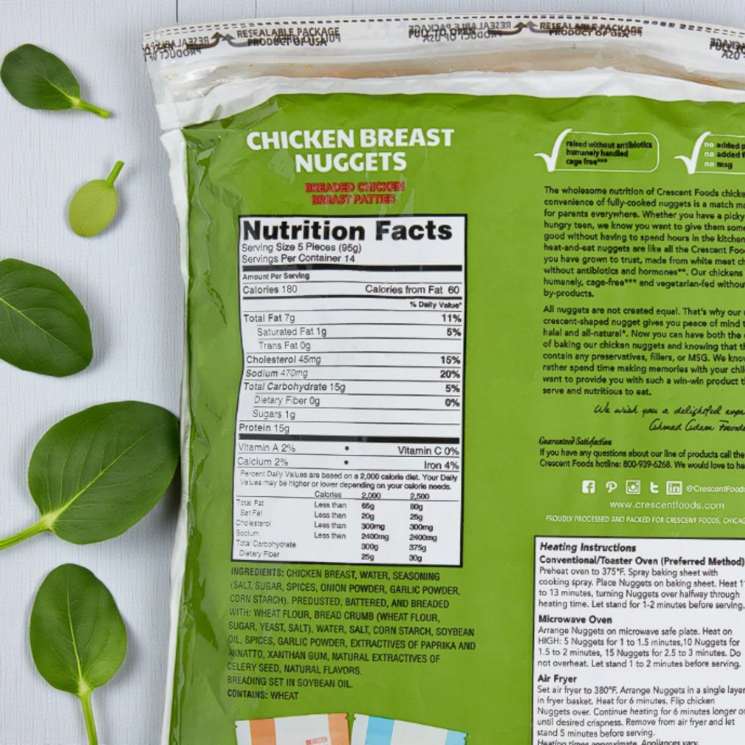 Back of a Crescent Foods Halal Chicken Breast Nuggets – 3 lbs package displays nutrition facts, ingredients, and preparation instructions, with green leaves beside the all-natural Crescent Foods chicken product.