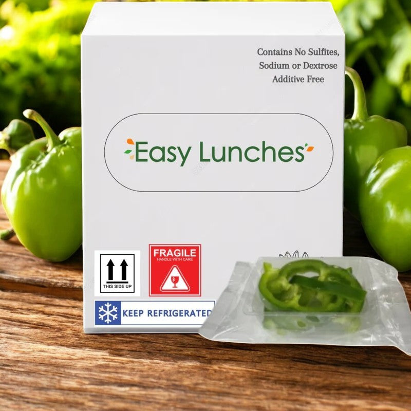 A box labeled "Easy Lunches" contains a 2.5 oz packet of Green Pepper Julienne, positioned in front with green peppers in the background. Includes handling instructions and is additive-free, offering convenience for busy days. Comes made to order with a 7-day shelf life on delivery.