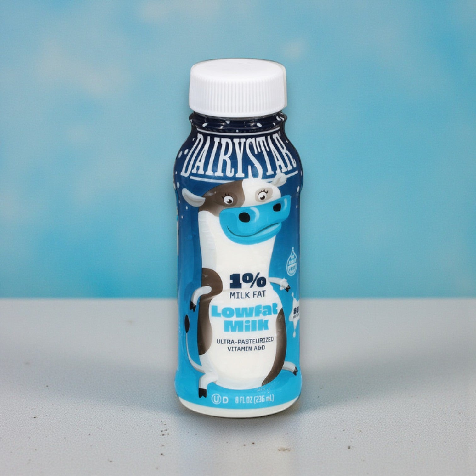 An 8 oz Dairy Star Low Fat 1% Milk bottle from the 24 pack displays a cartoon cow on its label with a blue background.