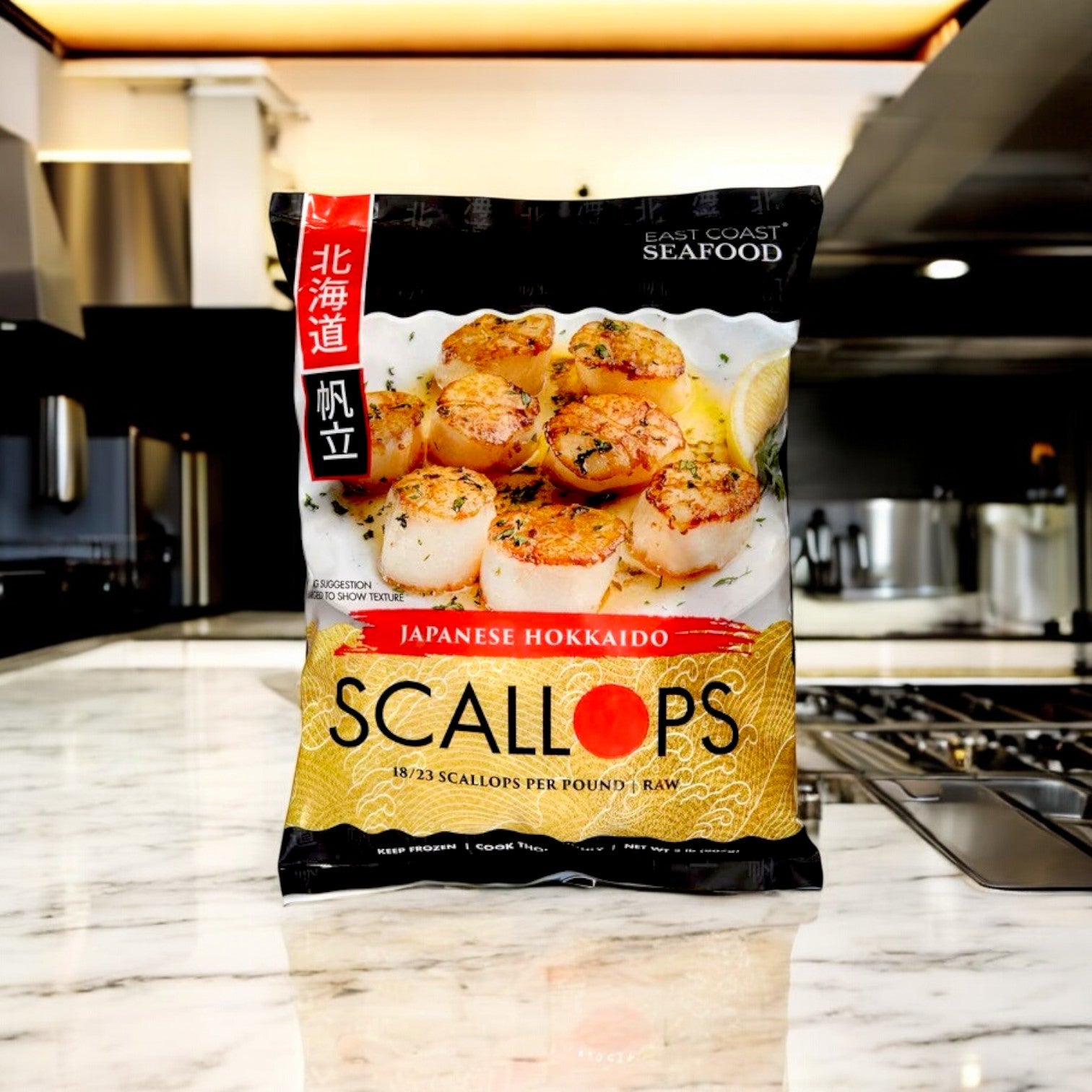 A bag of Kirkland Signature East Coast Seafood Japanese Hokkaido Scallops, Raw, 18-23 ct, 2 lbs rests on a marble countertop in a modern kitchen.