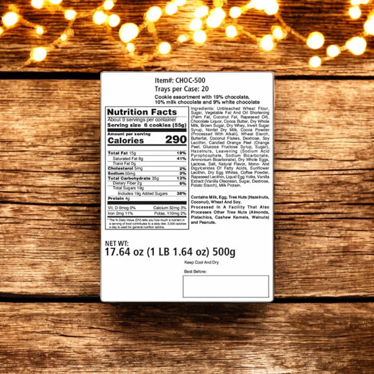 A nutrition label for Macy's R.H. Macy & Co. European Chocolate Biscuit Tin, elegantly displayed on a wooden surface with string lights in the background. The assortment, featuring premium chocolate biscuits, is branded under CHOC-500 and labeled to deliver 290 calories per serving with a total weight of 500g (17 oz).