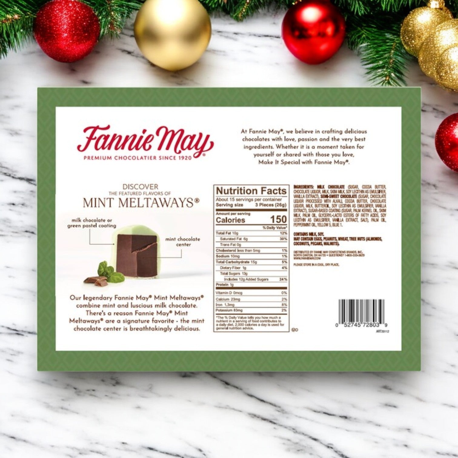 The packaging of a Fannie May Candy, Mint Meltaways, 1 Count displays a delightful mint chocolate experience with a touch of holiday spirit. Explore the product details and nutritional information surrounded by festive ornaments in the background.