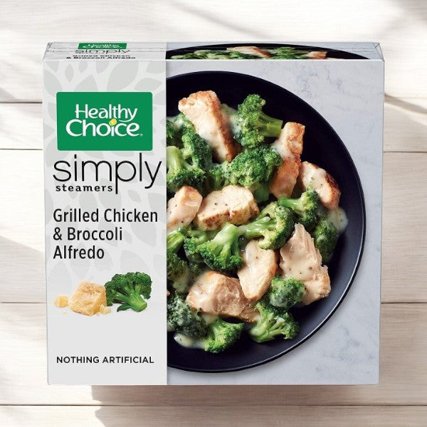 A Healthy Choice Meals Bundle, featuring 10 meals including Grilled Chicken & Broccoli Alfredo, sits elegantly on a wooden surface—a delicious and nutritious option.