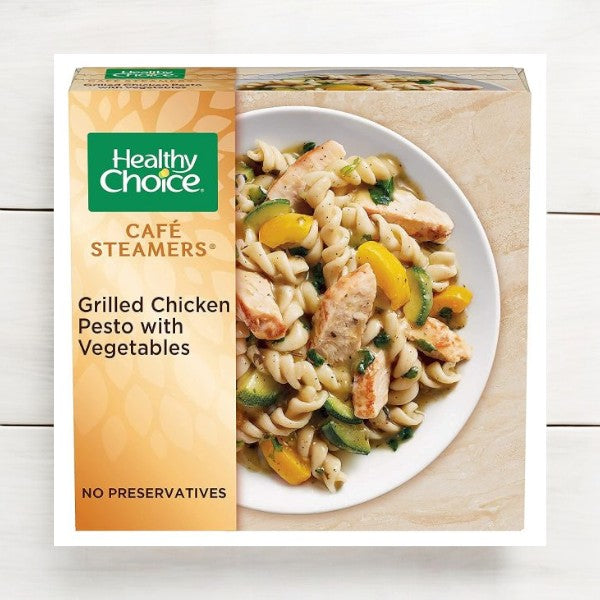 The Healthy Choice Meals Bundle features 10 nutritious meals, including the grilled chicken pesto with vegetables, perfect for health-conscious individuals. Displayed elegantly on a white wooden background, it offers delicious meal solutions for those prioritizing health.