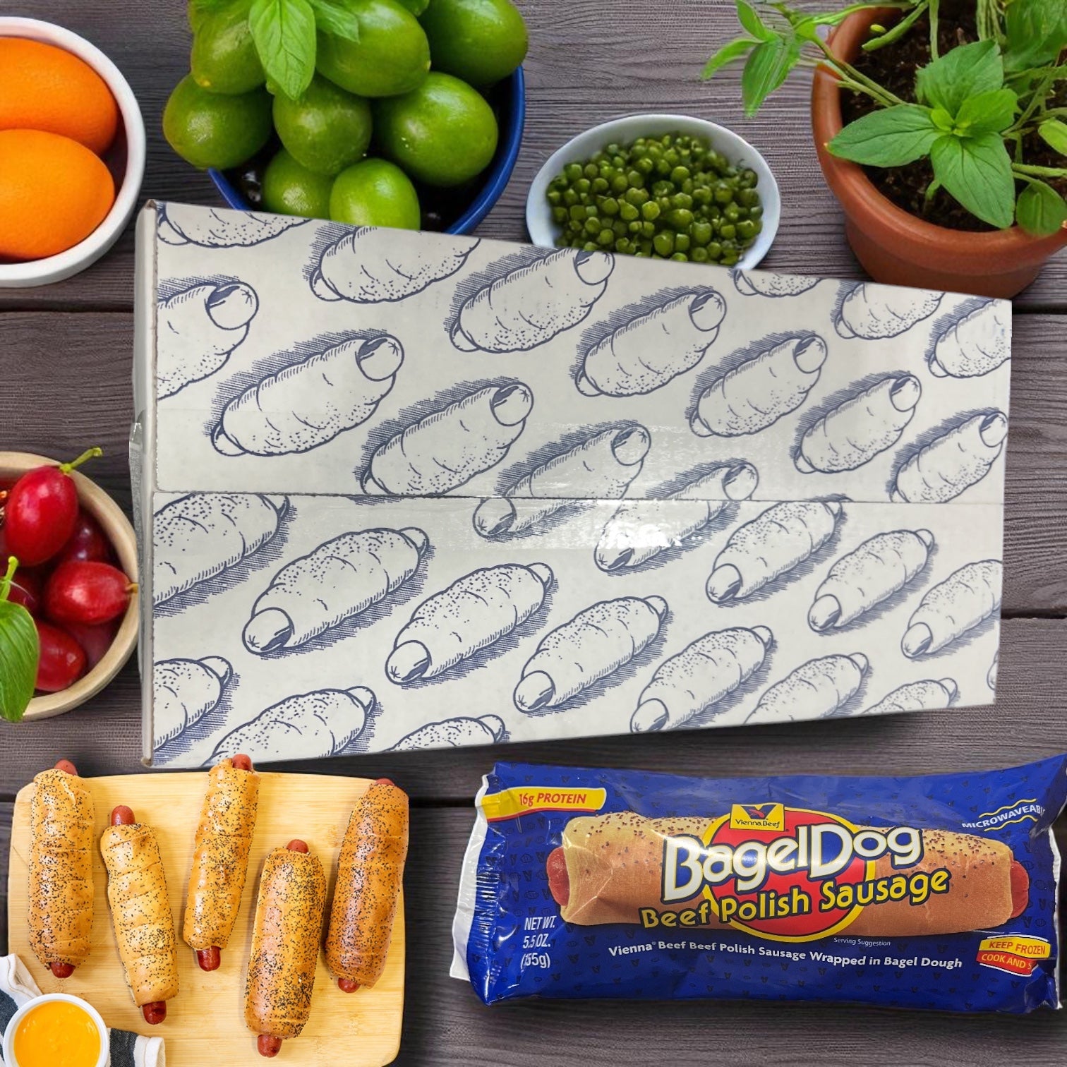 Vienna Beef Polish Sausage Bagel Dogs on a cutting board with dipping sauce, Vienna Beef packaging, and fresh fruits and vegetables arranged on a wooden table.