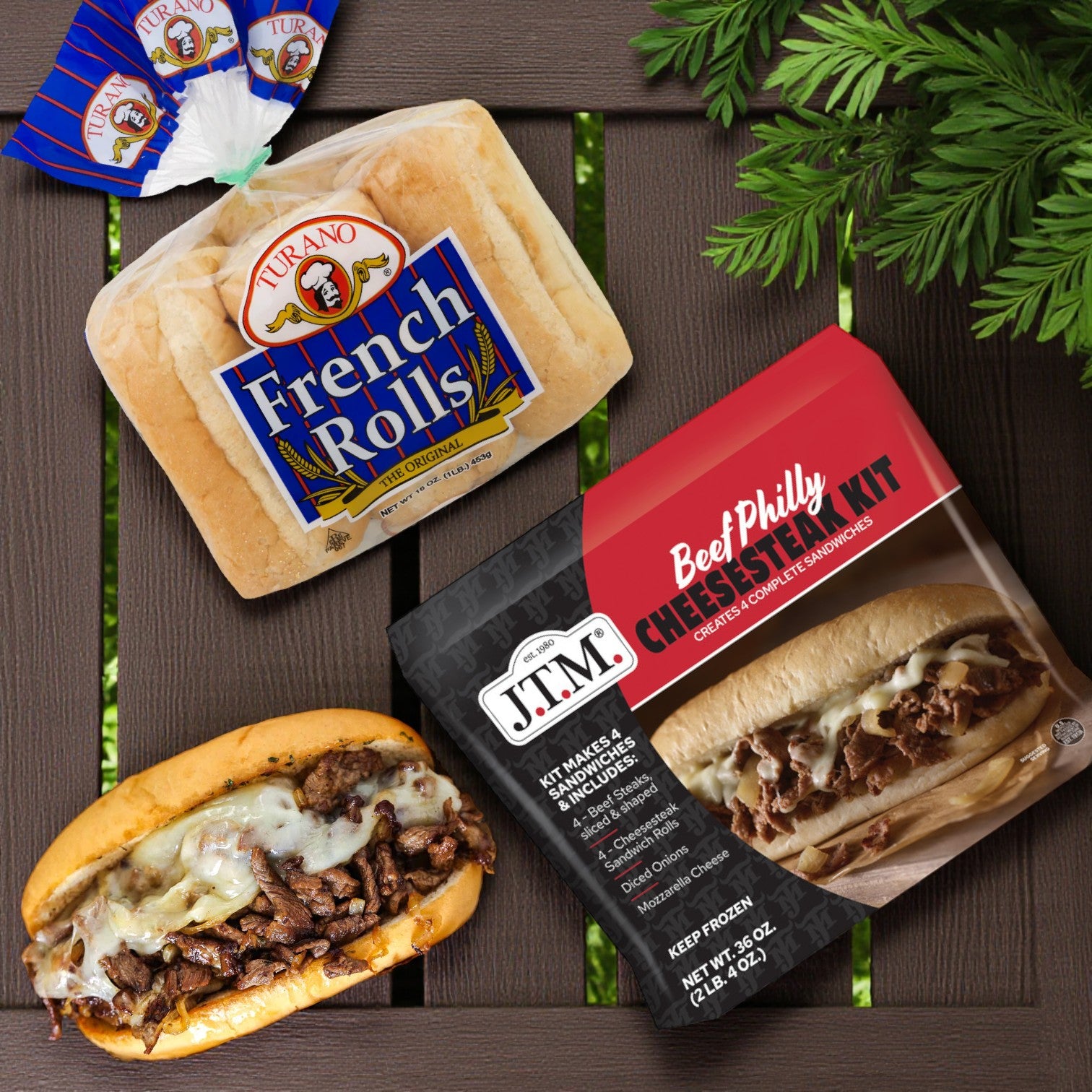 J.T.M. Beef Philly Cheesesteak Kit (2 lbs, makes 4 sandwiches) and Turano® French Rolls (6 ct/16 oz) are displayed on a wooden surface, ready to help you create classic Philly-style cheesesteak sandwiches.