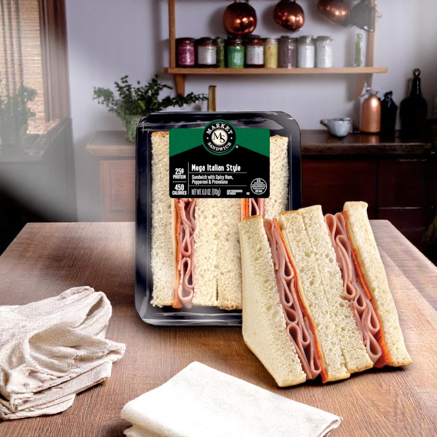 The E.A. Sween Market Mega Italian Style Sandwich Wedge – 6 oz (Individually Wrapped) sits on a kitchen table, with one half removed—offering deli-quality ham and cheese flavor and ideal grab-and-go convenience.