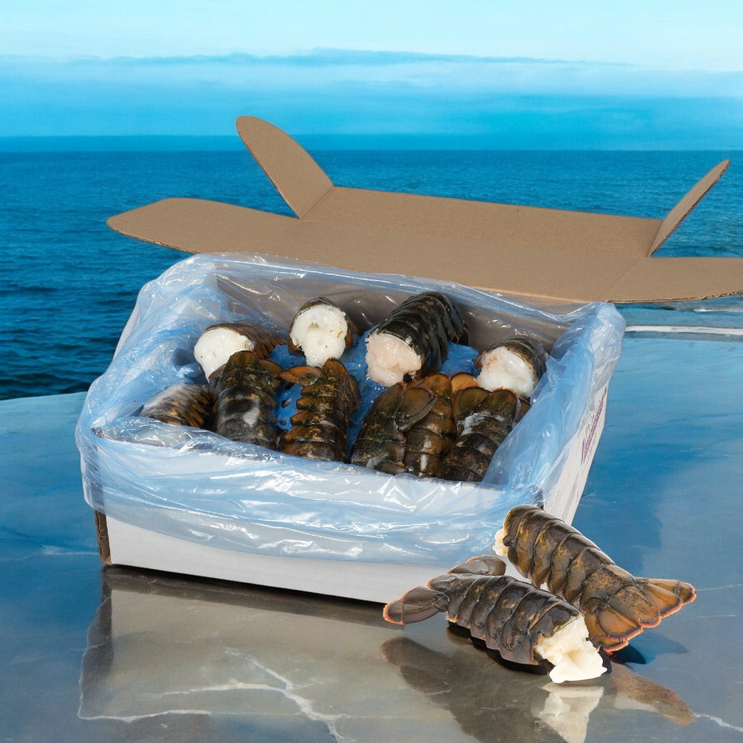 A Sysco Lobster Tail North Atlantic Premium 6-7 Ounce 10 Pounds box, lined with plastic, contains several lobster tails; two are displayed on a reflective surface in front of the box with the ocean visible in the background.