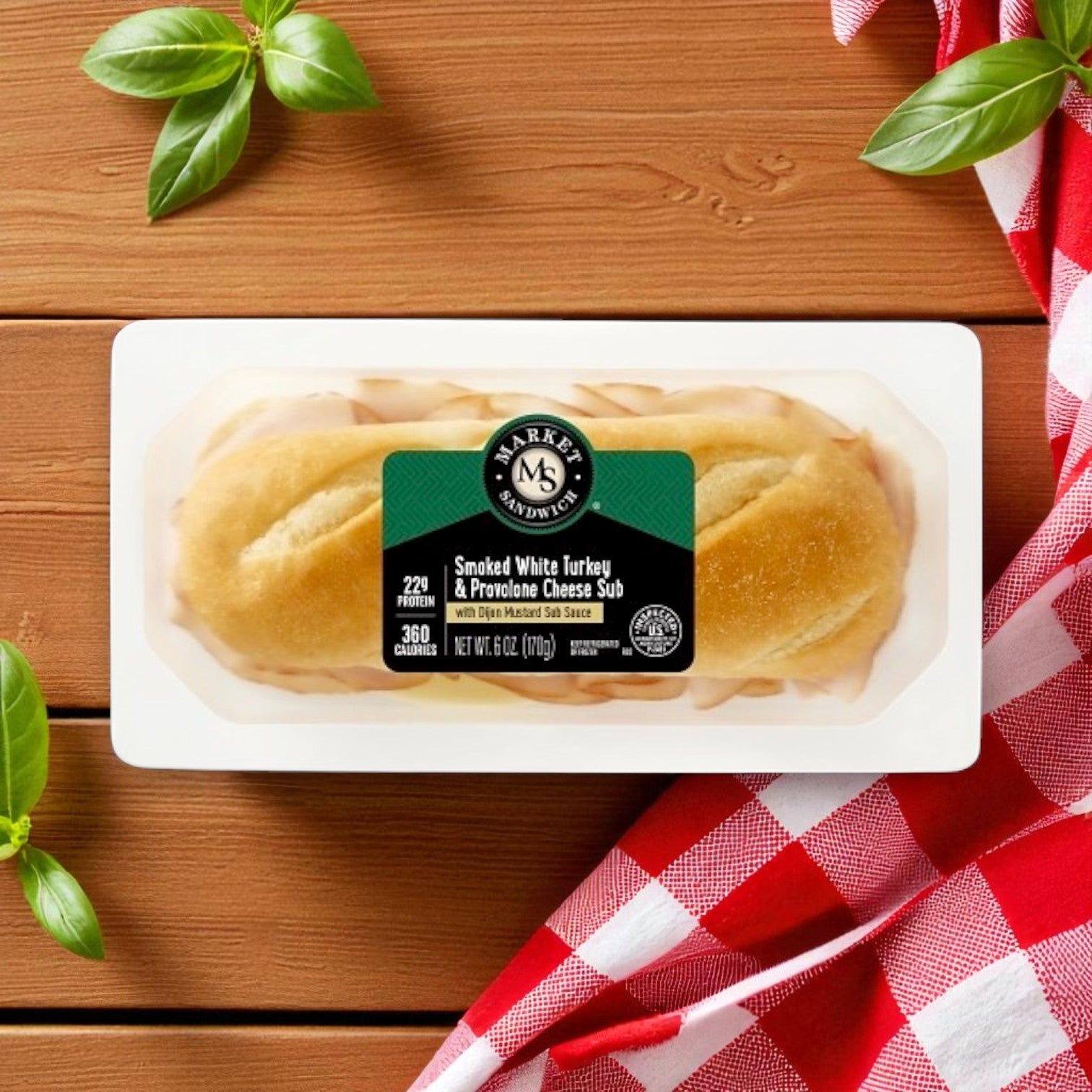 The E.A. Sween 8-Pack Market Sandwich Variety features 4 Chicken Caesar Wraps (8.6 oz) and 4 Turkey & Provolone Subs (6 oz), displayed on a wooden surface with basil leaves and a red-and-white checkered cloth nearby.