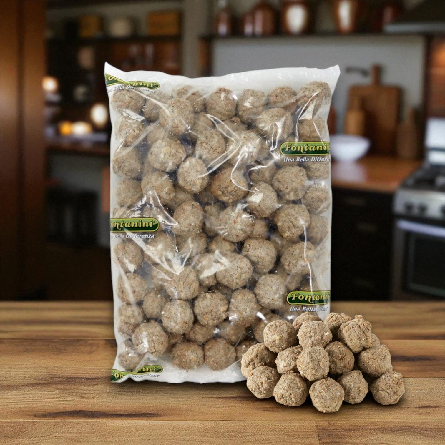 A sealed Sysco Fontanini Meatball Italian Beef Pork Fully Cooked 1 Ounce 2/5 LB bag sits on a kitchen wooden surface, with several savory meatballs displayed in front.