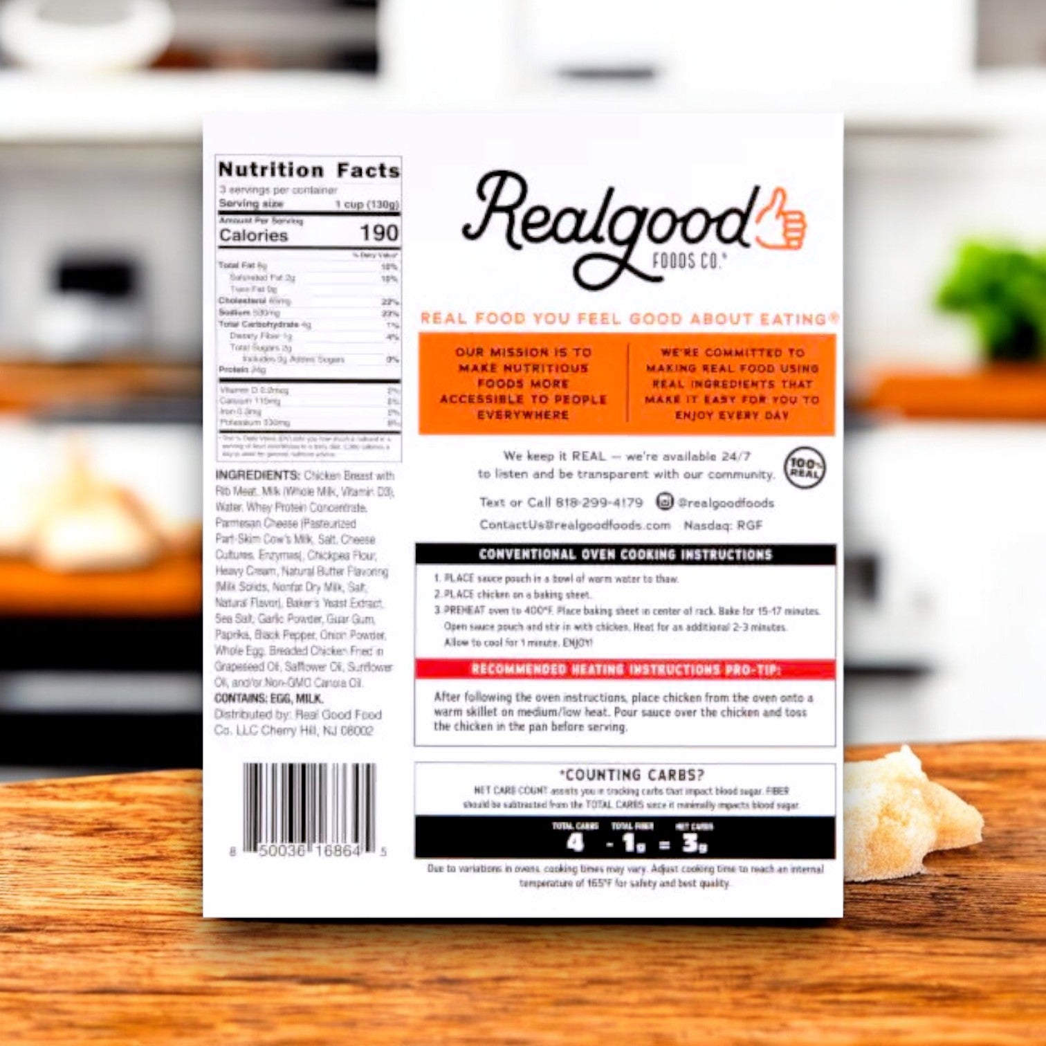 Back of a Real Good Foods Low Carb Parmesan Garlic Boneless Chicken Bites (15 oz.) box on a kitchen counter, featuring nutrition facts, ingredients, gluten-free label, high-protein and low-carb callouts, cooking instructions, and brand mission.