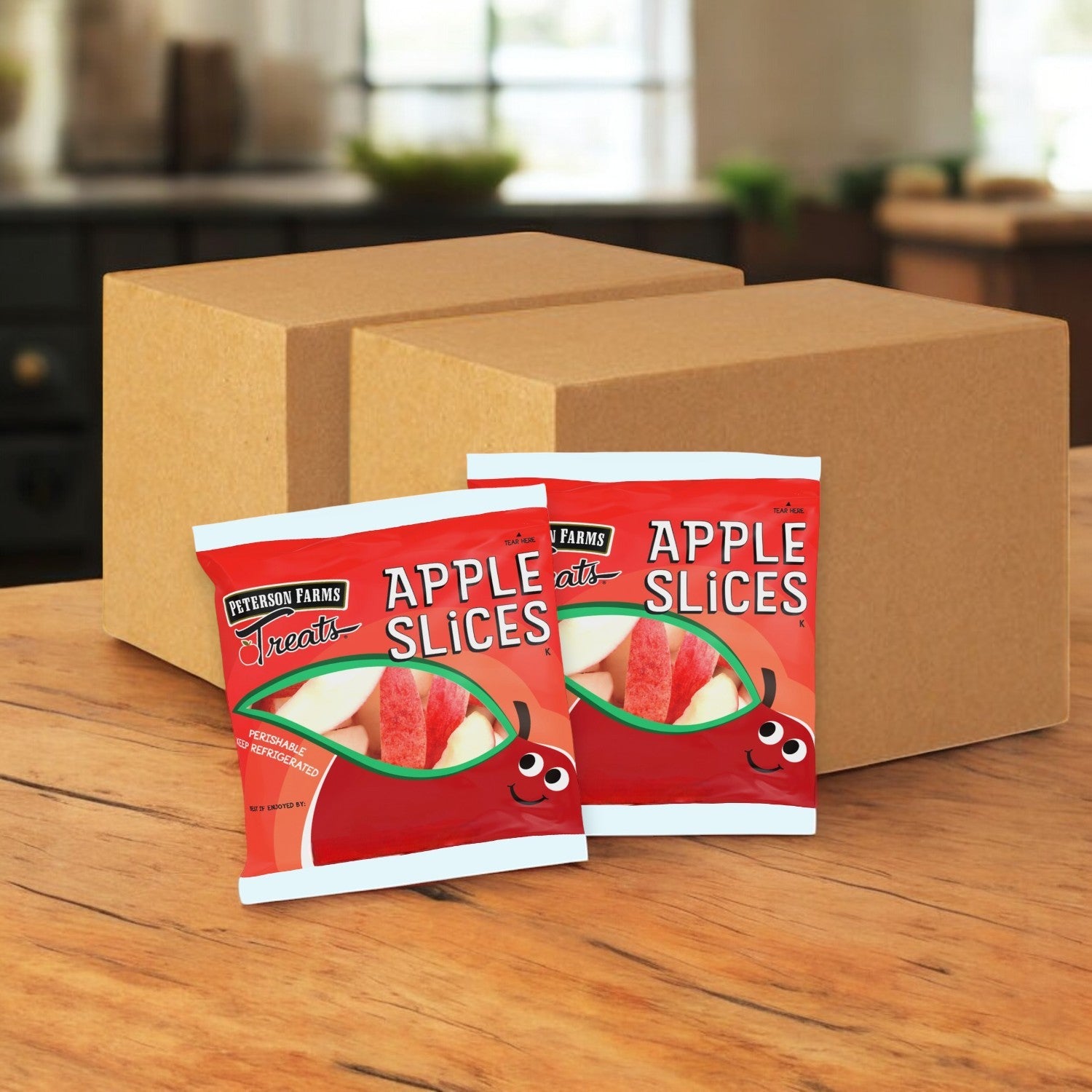 Two packets of Peterson Farms Fresh Apple Slices sit in front of cardboard boxes on a wooden surface, providing a perfectly healthy snack option.