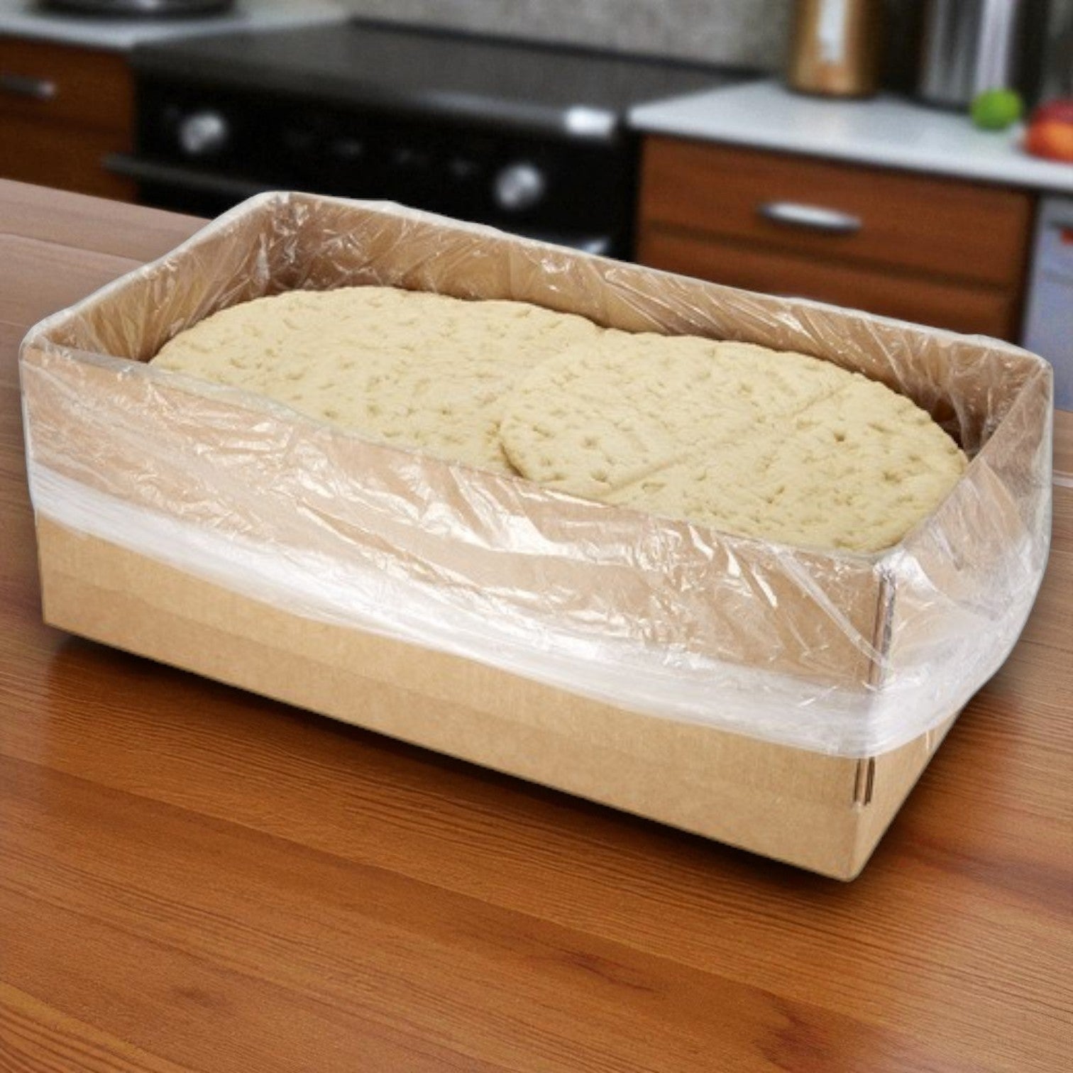 A cardboard box of Sysco Fontanini Thick Rustic Parbaked Pizza Crust, 12" size, 24 count, sits on a wooden kitchen counter—ideal for stocking up on bulk pizza crusts.