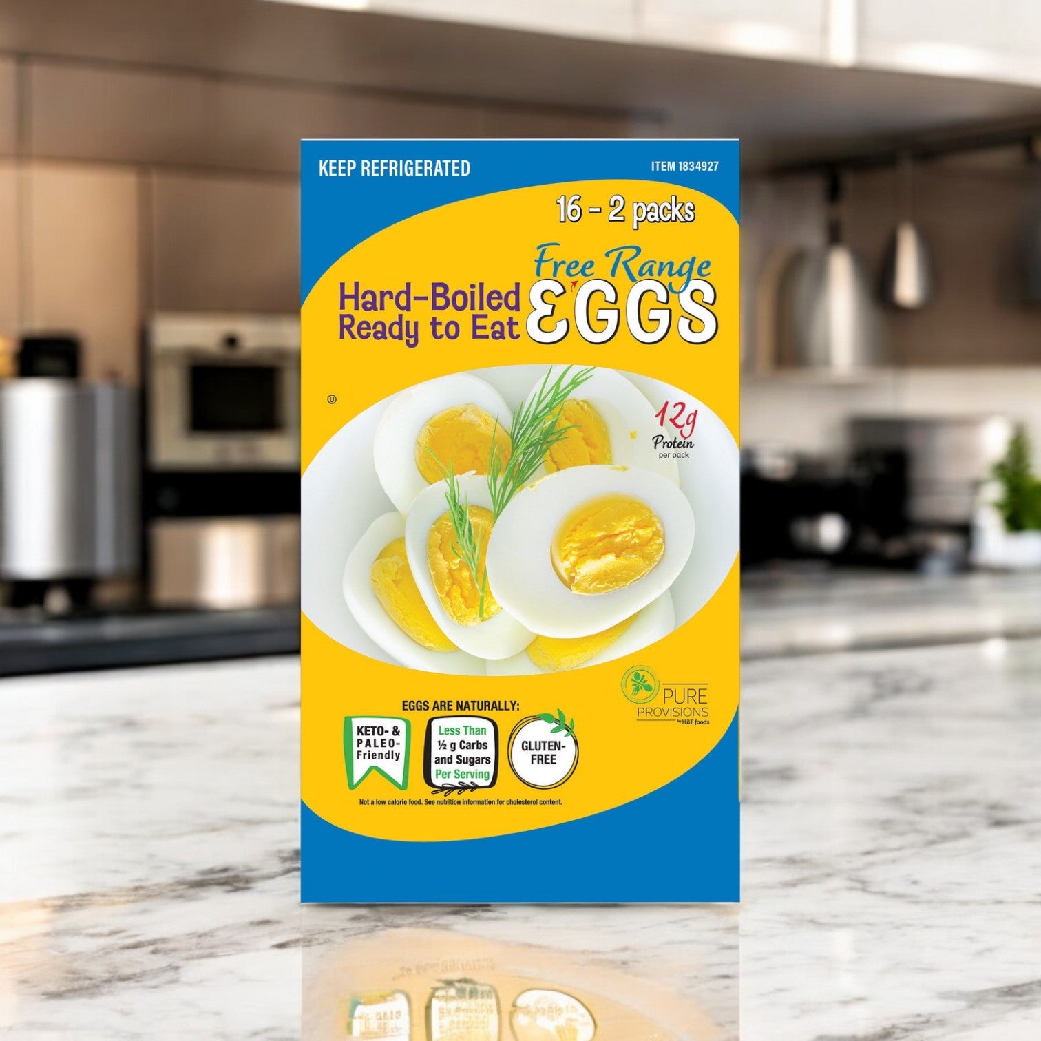 A box of Pure Provisions Hard Boiled Eggs, Free Range | 16 Packs is shown on a kitchen counter, with a refrigerator and stove in the background.