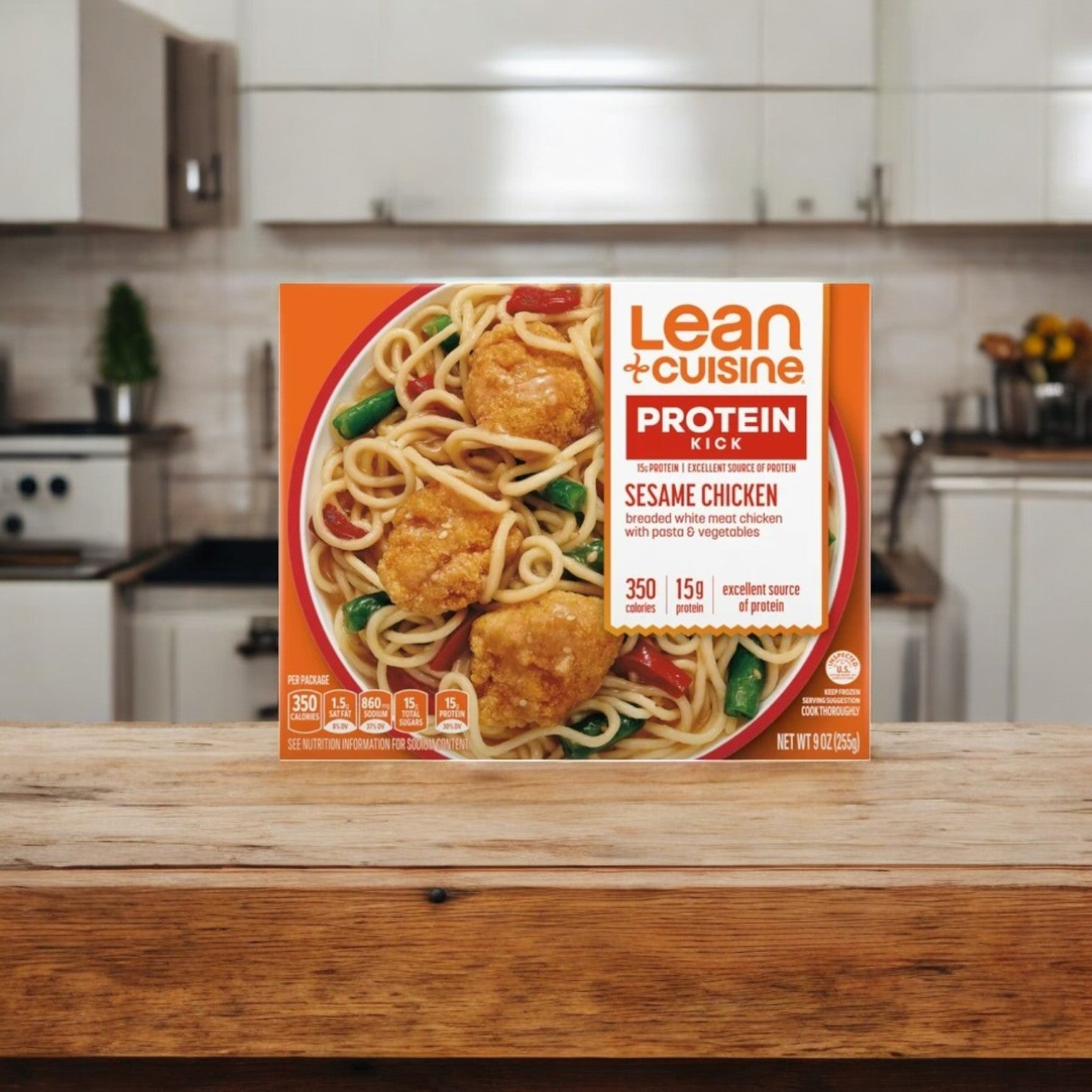 A Lean Cuisine Sesame Chicken-9 Oz-1ct. meal from Lean Cuisine is shown on a wooden counter in a warm kitchen atmosphere.