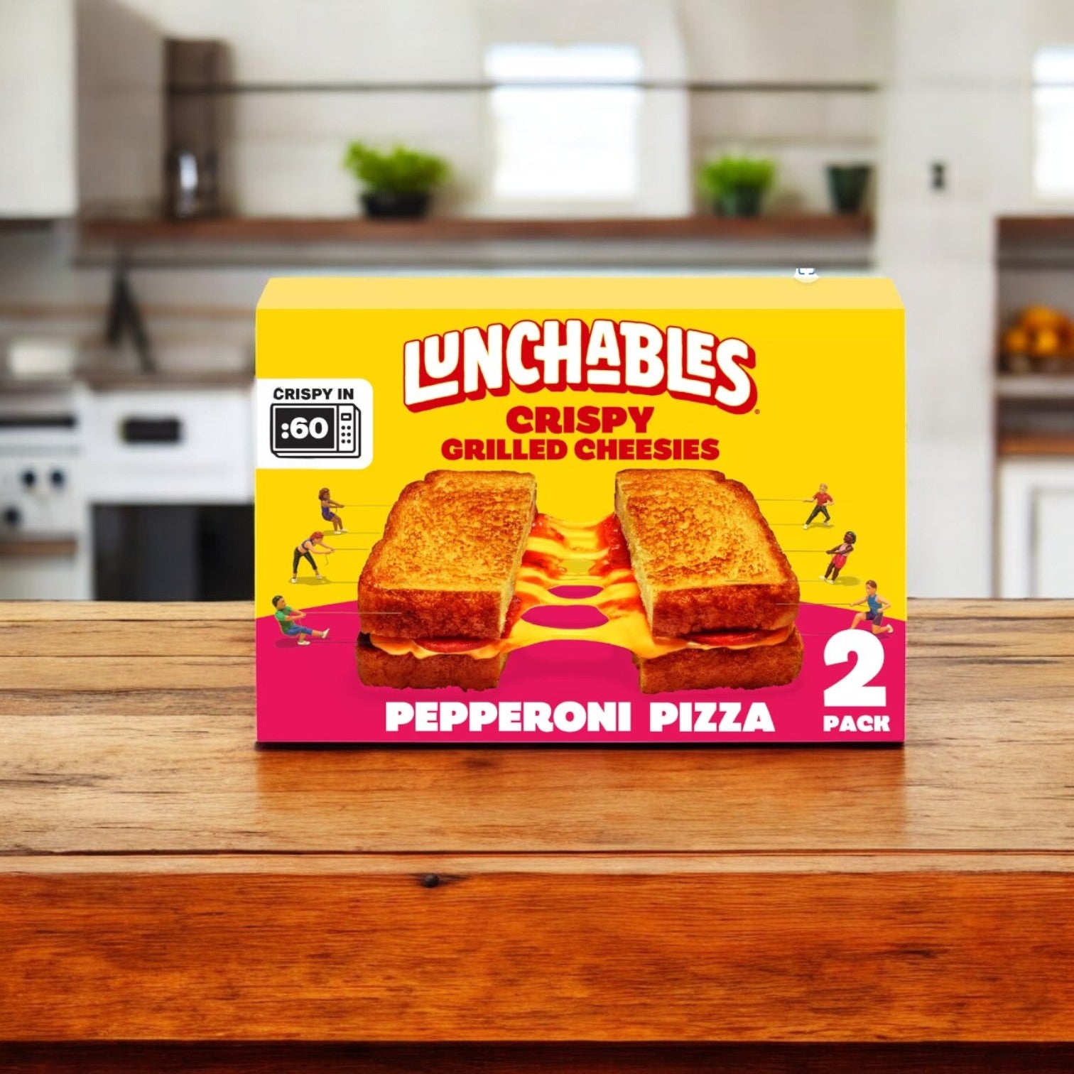 A pack of Lunchables Pepperoni Frozen Grilled Cheesies, with two pieces, sits on a wooden counter, ideal for quick meals in your kitchen.