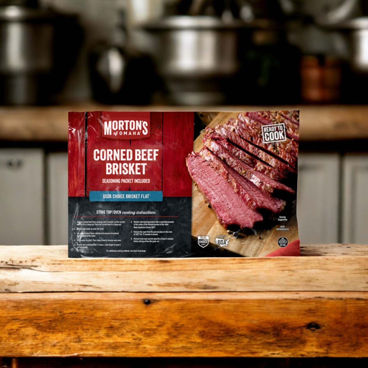A 4lb pack of Morton's Of Omaha Corned Beef Brisket sits on a wooden counter, featuring sliced brisket and "Ready To Cook" info—ideal for making a tasty St. Patrick's Day meal.