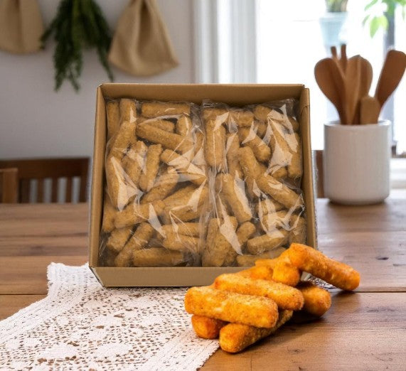 A box of Sysco Mozzarella Cheese Sticks Battered (6 count, 2 lbs, 1 case) sits on a wooden table with some sticks in front on a lace runner, ideal for pairing with other crispy appetizers.
