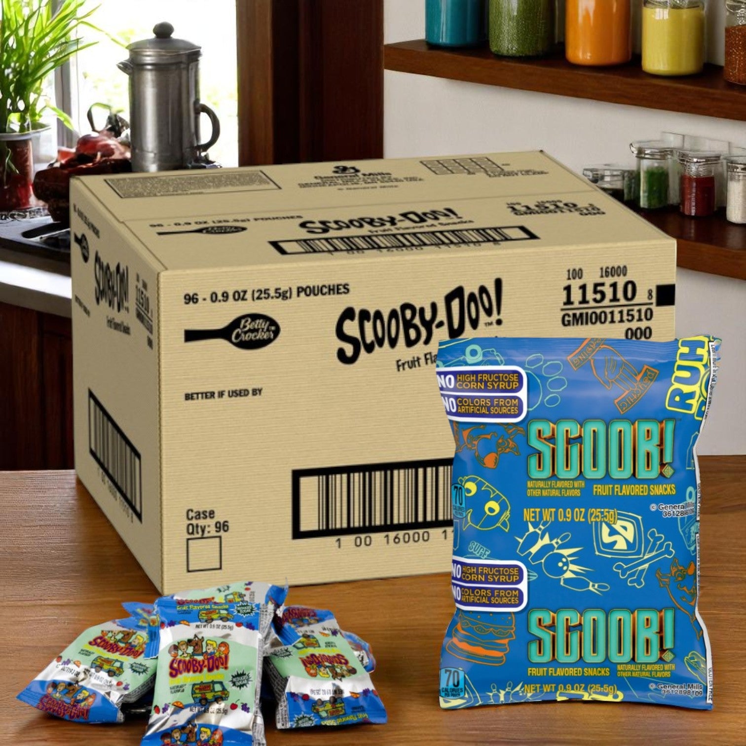 An open case of General Mills Scooby-doo Shape Fruit Snacks (96 pack, 0.9 oz) sits on the kitchen counter, with several fun fruit-flavored pouches displayed in front.