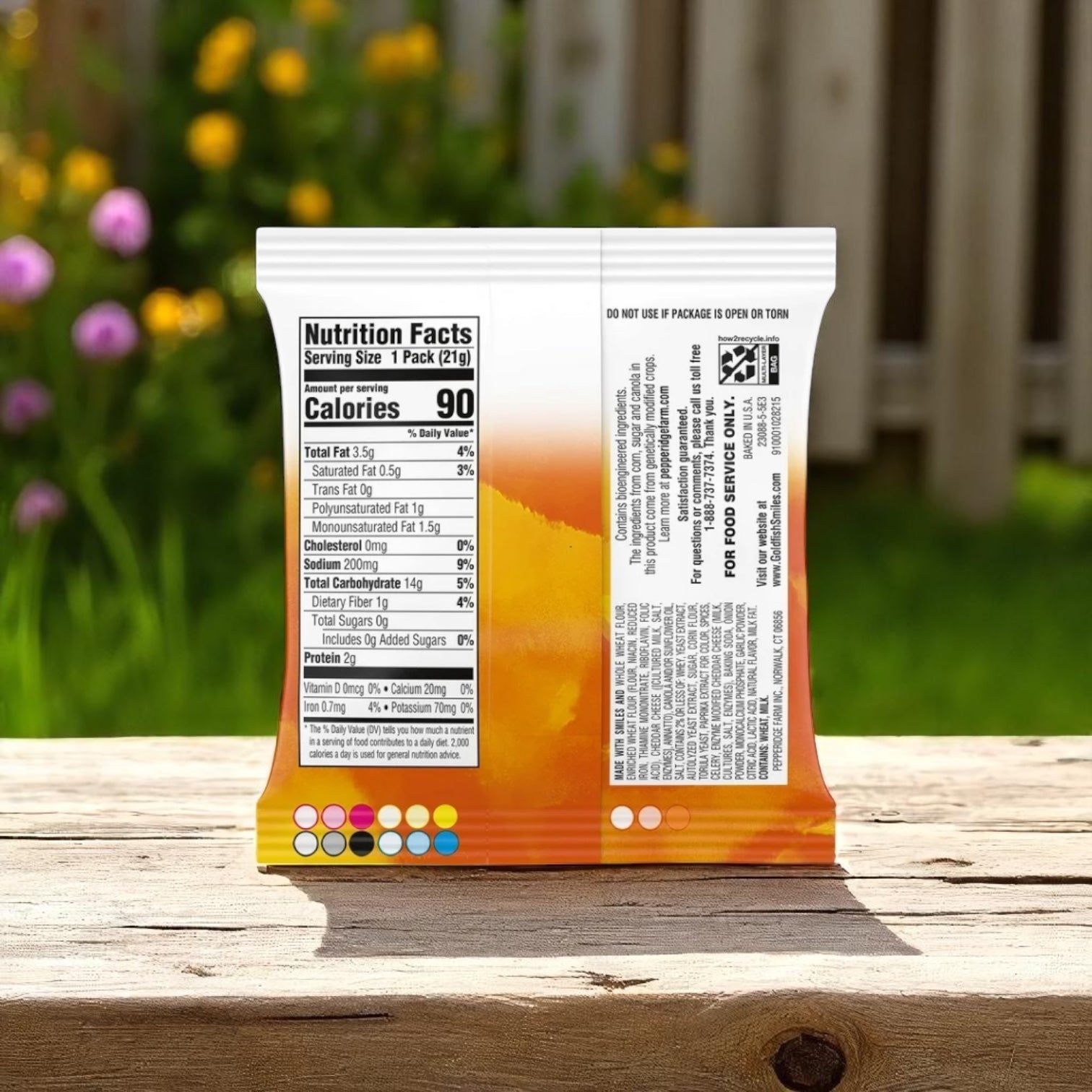 A single .75 oz. bag of Easy Lunches Goldfish Whole Grain Cheddar Crackers stands upright on a wooden surface outdoors, displaying nutrition facts—a wholesome snack made with real cheddar cheese.