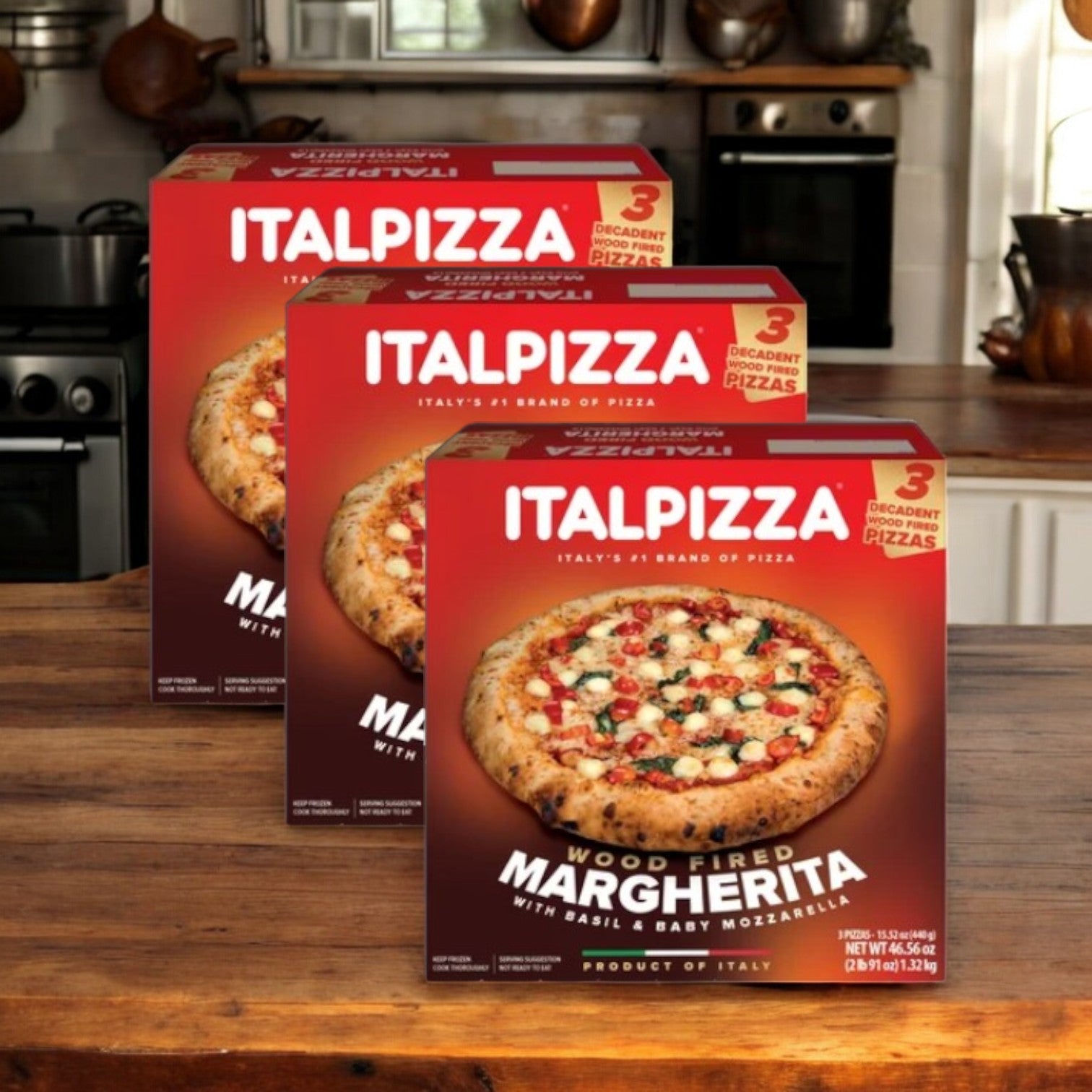 Three boxes of Easy Lunches ITALPIZZA Wood Fired Pizza Margherita, 15.5 oz, 3 Count-3 Cases, are displayed on a kitchen counter with a stove and cookware in the background.