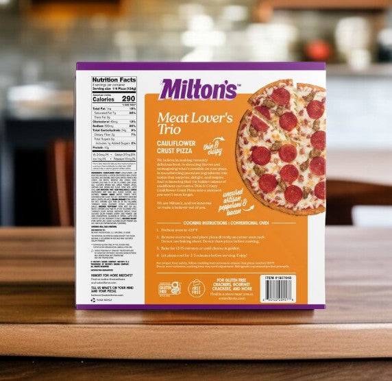 Milton's Meat Lover's Cauliflower Crust Pizza, 17.5 oz, 2-count, is showcased on the kitchen table, its gluten-free label and nutrition facts visible on the box from Milton's.