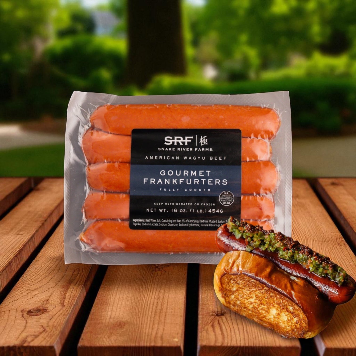 Snake River Farms Wagyu Hot Dogs - 1 lb and Vienna Beef Hot Dog Bun 10 Pack are shown, with a grilled hot dog in a Vienna Beef bun topped with condiments on a wooden outdoor surface.
