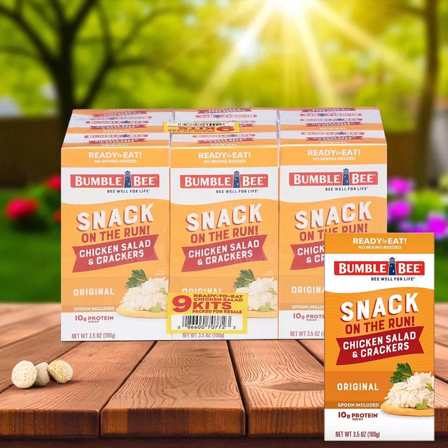 A 9-pack of Bumble Bee Snack On The Run Chicken Salad Kits, 3.5 oz., is shown on a wooden surface with a blurred outdoor background, highlighting this convenient and ready-to-eat option from Bumble Bee.