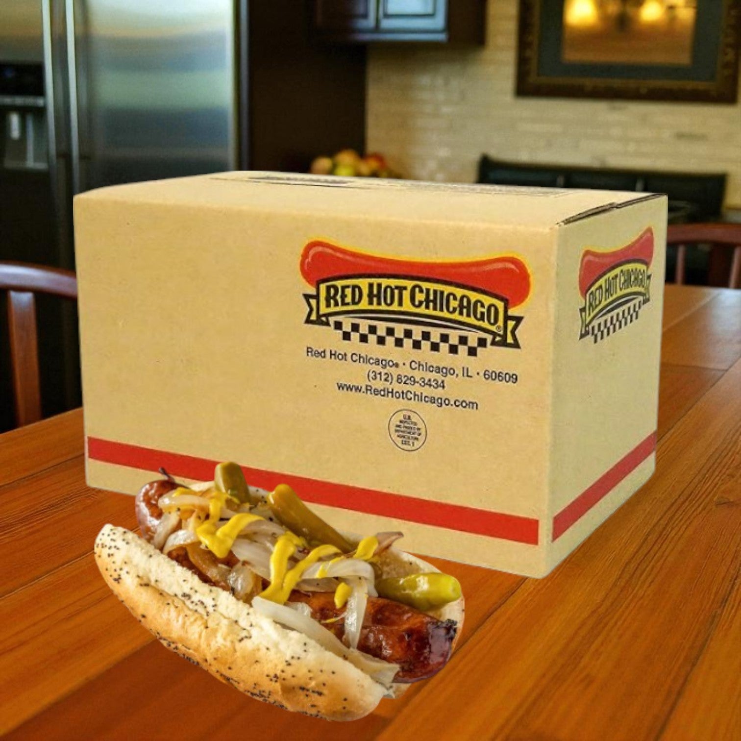 A box of Red Hot Chicago Beef Polish Sausage 6" 6's (10 lb case) sits on a wooden table with a fully loaded Chicago-style hot dog in front; a kitchen is visible in the background.