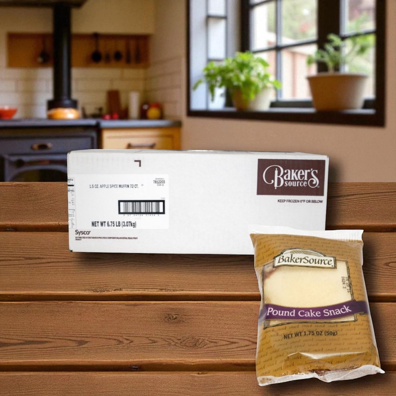 A boxed case of Baker's Source Classic Cake Pound, 1.75 oz individually wrapped slices (24 count), is displayed on a wooden surface with a kitchen in the background.