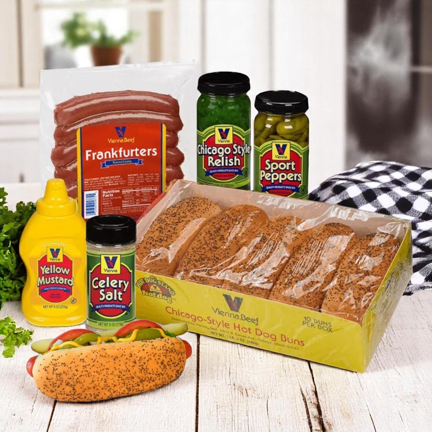 The Vienna Beef Chicago-Style Hot Dog Kit – Serves 10, includes Vienna Beef frankfurters, poppy seed buns, relish, sport peppers, celery salt, and mustard—all the classic Chicago-style ingredients displayed on a table.