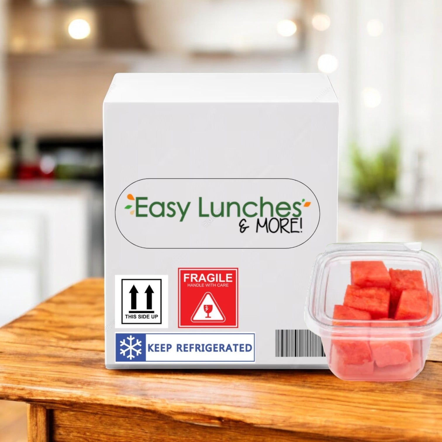 A white Easy Lunches box with handling and refrigeration stickers sits on a table next to a container of Watermelon Chunks Fresh – 2.5 oz., perfect for a healthy snack; 50 count, made to order, with a 7-day shelf life.