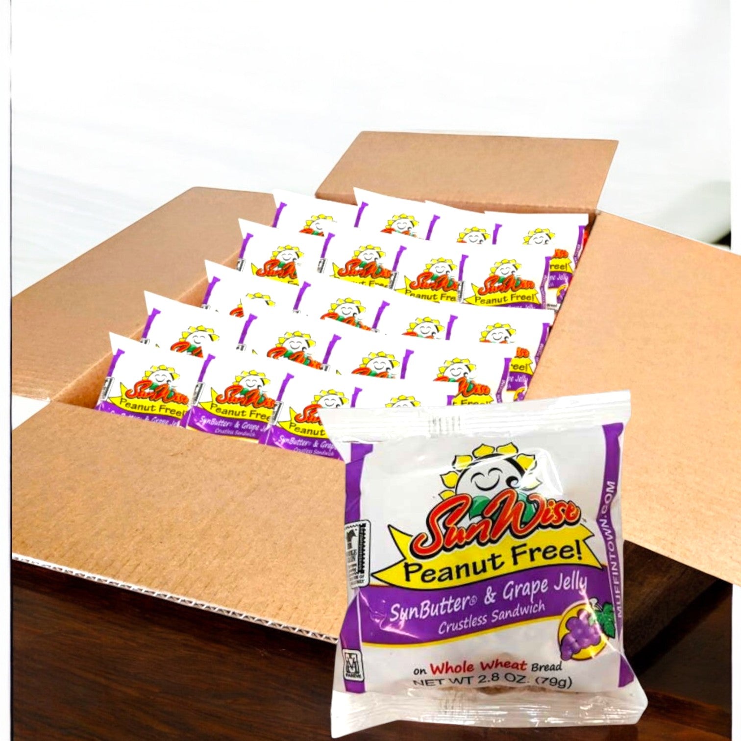 A Sunwise case contains 96 individually wrapped, nut-free SunWise Sunbutter and Grape Jelly sandwiches, with one sandwich package shown in front.