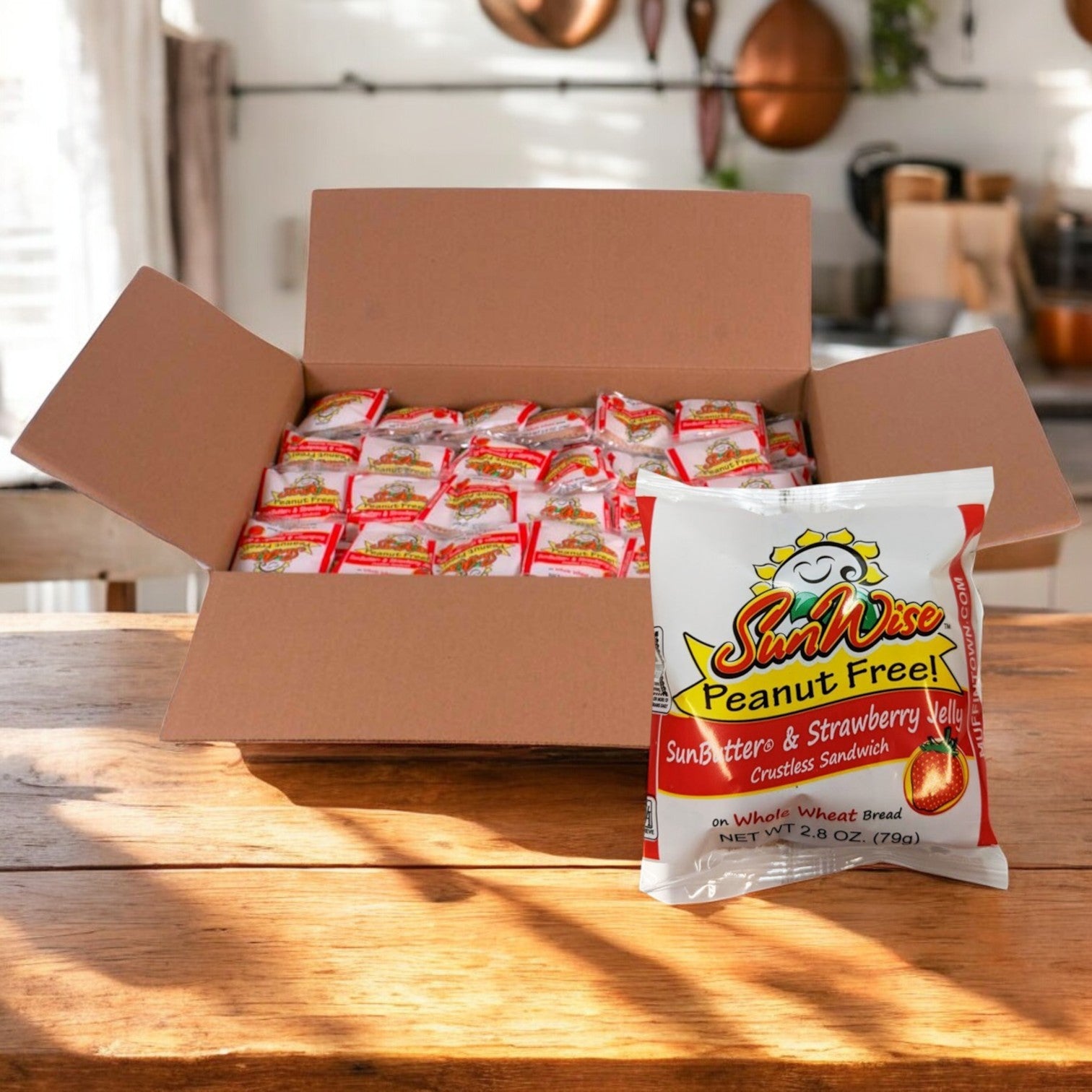 A case of Sunwise SunButter and Strawberry Jelly Sandwiches (96 x 2.8oz, peanut-free) sits on a wooden table, with one individually wrapped sandwich displayed in front.