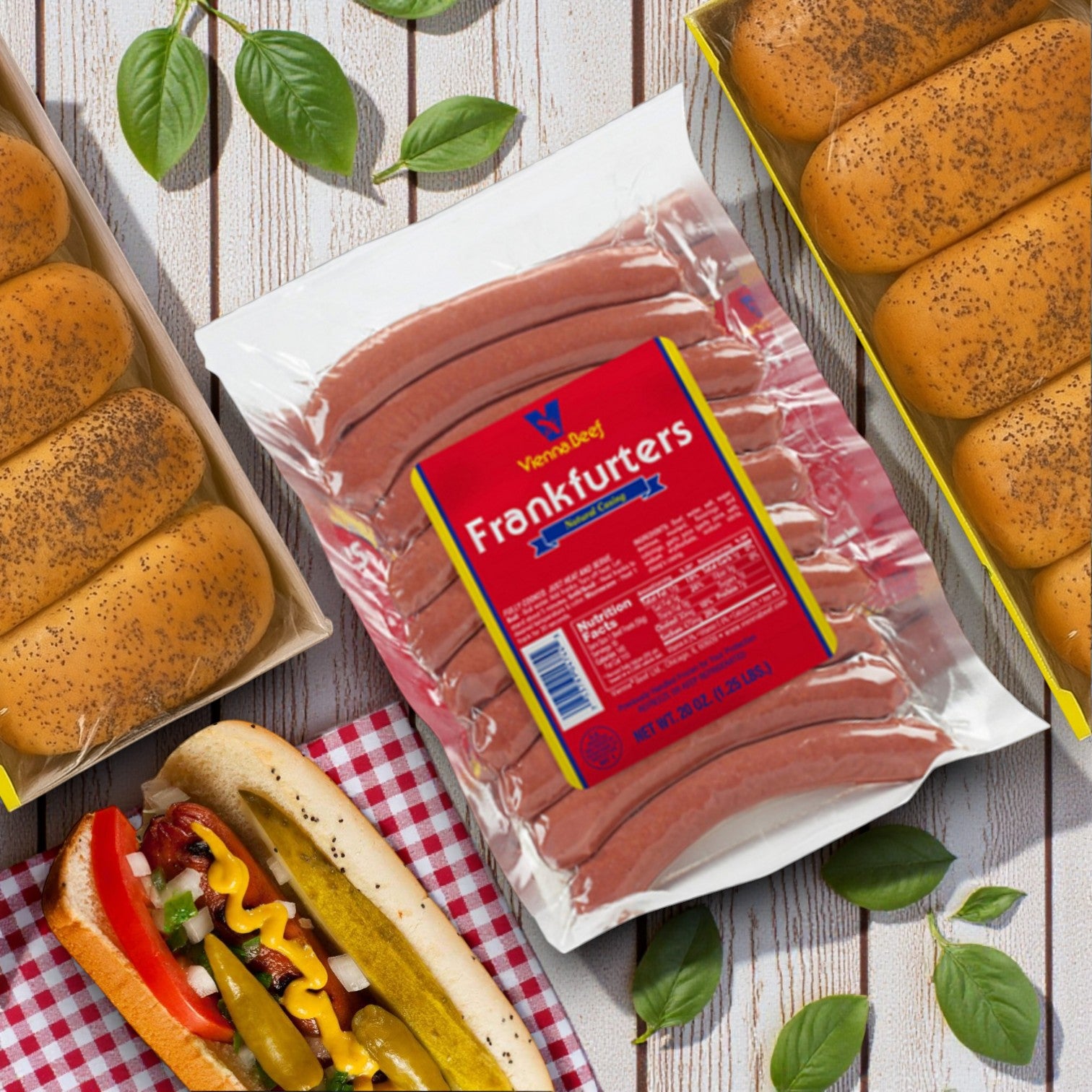 A Vienna Beef Hot Dog Kit – Frankfurters + Poppy Seed Buns sits on a table, alongside leaves and a Chicago-style hot dog topped with vegetables and condiments.